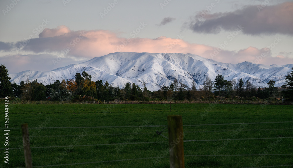 Fototapeta premium Snow-capped mountains at sunrise. Winter landscape of Canterbury. South Island. New Zealand.