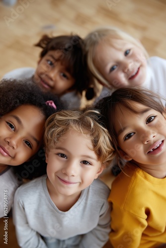 Smiling group of diverse children looking up at camera together