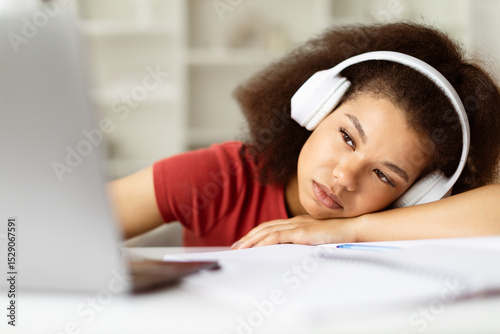 Tableau sur toile Bored or tired African American female student at home, leaning head on hand, we