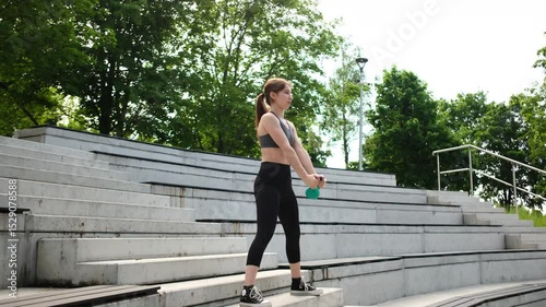 Fit Girl Exercising In The Park, Lifting Weights And Using A Kettlebell