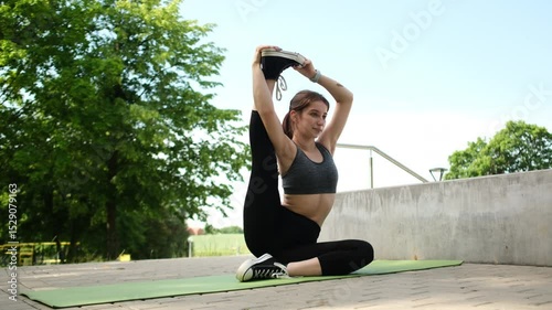 Girl Doing A Fitness Routine And Stretching Legs At The Park