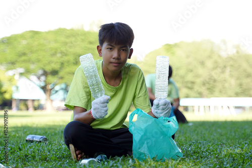 Asian boy is a student in the Environmental Club and his friends help collect and sort waste plastic water bottles and glass bottles for recycling or reuse. In the concept of saving the world.