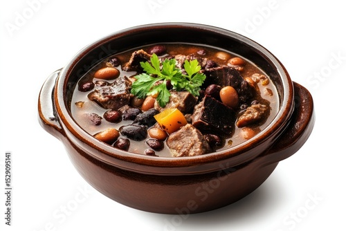 Traditional hearty beef and vegetable stew in a rustic clay bowl with fresh herbs, variety of vegetables and tender meat pieces in savory broth