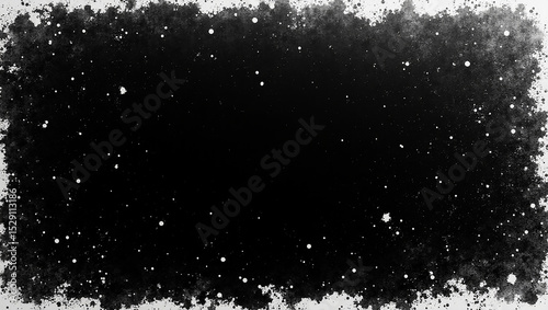 Black space with grainy, diffuse borders is decorated with bright dots. The abstract image could be used as a background for many designs.

