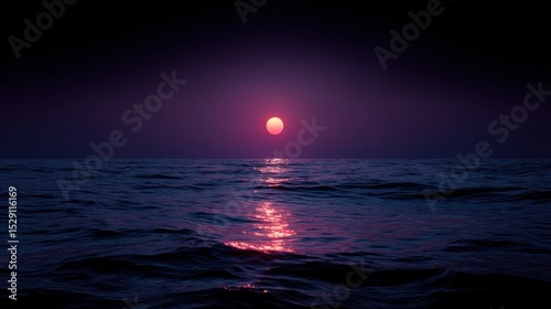Sun or moon over dark ocean water reflecting light on the surface.