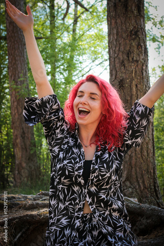 Beautiful girl with red hair on a sunny summer cottage.