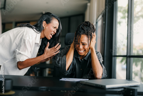 Boss shouting at frustrated worker, bullying and emotional abuse at work. Stressful work environment