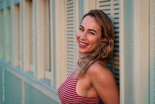 Israeli beauty with blonde hair and a red striped shirt on summer vacation in Tel Aviv Free Download Israeli beauty with blonde hair and a red striped shirt on summer vacation in Tel Aviv - GFXLoad