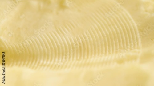 Butter with creamy textured surface. Fat dairy product. Macro shot. Rotation