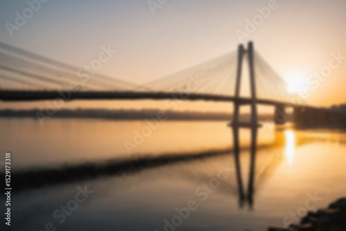 blurry photo of bridge in the afternoon showing beautiful sunset radiating from the corner of the bridge