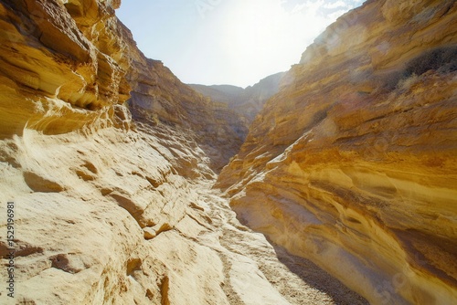 Desert canyon with stratified sandstone layers golden hour shadows no landmarks