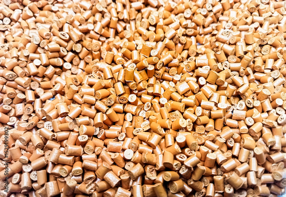 Fototapeta premium Brown polymer granules, brown masterbatch granules, cold cutting material type, isolated on white background for product catalog design of plastic manufacturing industry company profile 