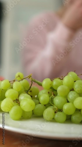 Kids In Pajamas Grab Grapes From The Plate At Breakfast At Home, Vertical Video