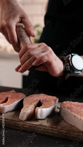 Woman Preparing Healthy Dinner By Salting Raw Red Salmon For Family Cooking, Vertical Video