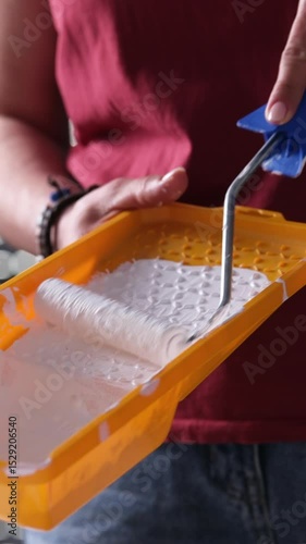 Girl Painting With White Paint Using A Roller And A Brush With A Yellow Paint Tray, Vertical Video