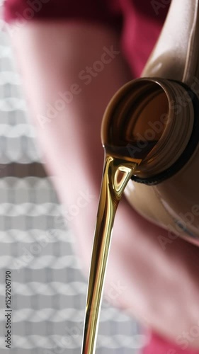 Mechanic With Canister Of Motor Oil Pouring From It, Vertical Video