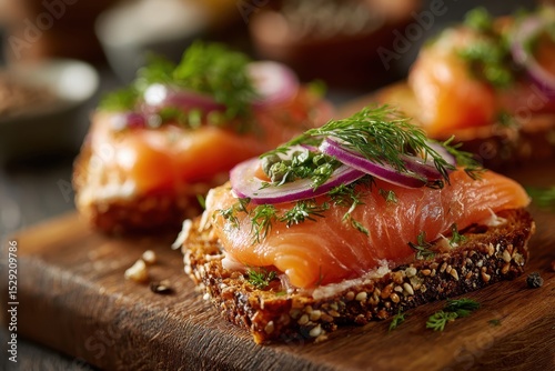 Delicious open-faced sandwiches with smoked salmon, cream cheese, red onion, and dill, served on a rustic wooden board, presenting a gourmet and healthy appetizer option.