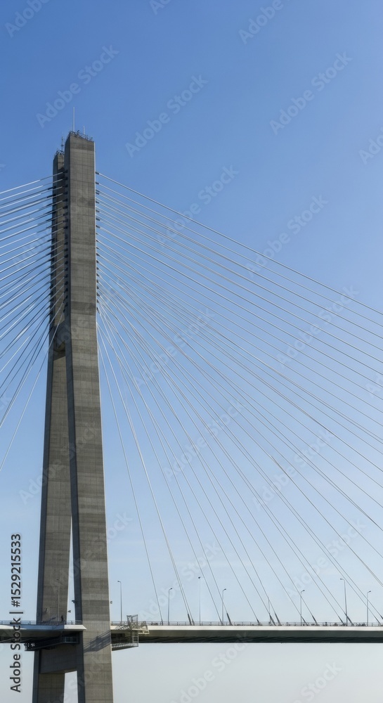 Fototapeta premium Arthur Ravenel Bridge Tower and Cables Against a Clear Blue Sky