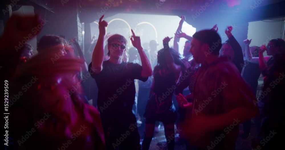 Diverse Party Crowd Enjoying Time in an Underground Nightclub, Dancing Energetically Under Pulsating Lights and Inspiring Music. Young Men and Women Having an Emotional Night Out