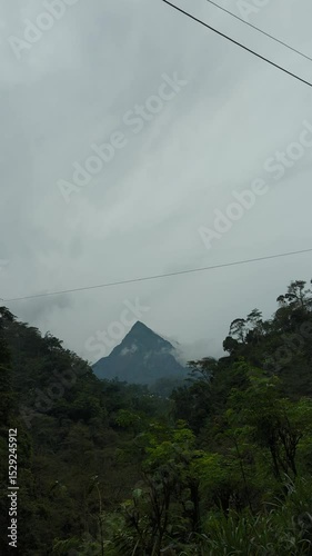 view of towering cone-shaped mountains with settlements in the mountain valleys.
