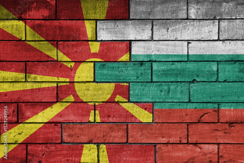 colourful painted big national flag of bulgaria and flag of macedonia on a massive old brick wall background. concept