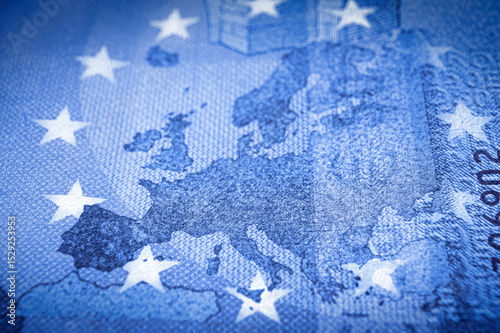 Shallow focus on Europe map from an Euro banknote in blue tone.