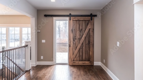 Sliding barn door in rustic wooden finish installed in small entryway