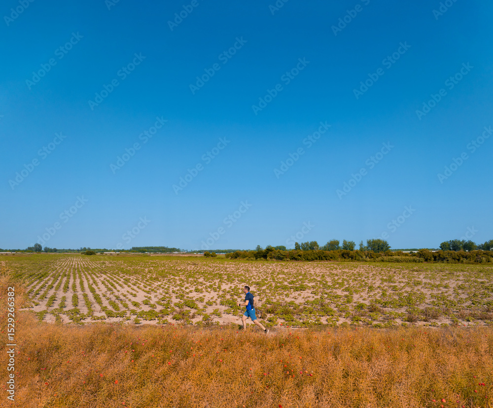 Fototapeta premium Caucasian man running in nature.