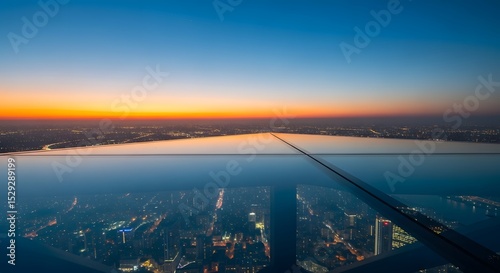 Wallpaper Mural Aerial View of a City at Sunset Airplane Wing, Illuminated Buildings, Horizon, Blue Sky and Orange Glow. Torontodigital.ca