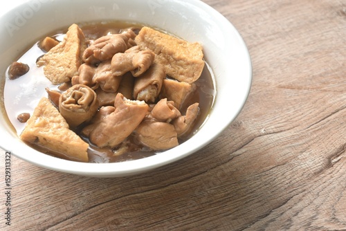 boiled braised slice pork innards and tofu in black Chinese herb soup on bowl