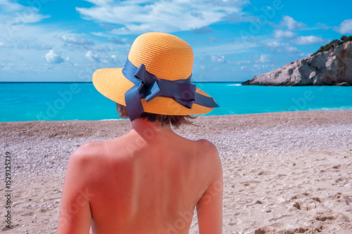 Young woman relaxing on the beach near the sea during a summer season