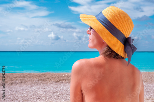 Young woman in hat on the beach