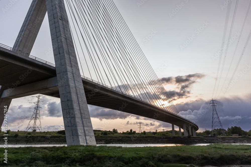 Fototapeta premium Flintshire Bridge stands prominently in the soft light of early morning, with its cables and concrete structure leading into the distance