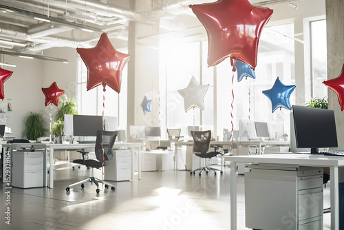 Modern office workspace decorated with red foil balloons in the shape of stars near each table, white interior, open space office, monitors on white tables. USA Independence Day, themed treats