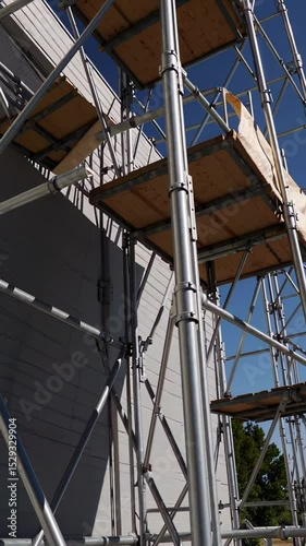 Wallpaper Mural Metal scaffolding swaying dangerously during construction work, revealing potential safety risks against blue sky backdrop of urban development project Torontodigital.ca