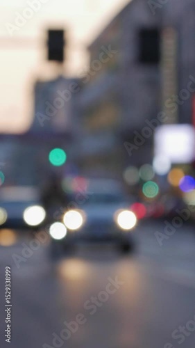 Soft bokeh effect highlights colorful traffic lights in a bustling metropolis