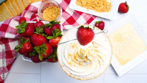 Making Strawberry Shortcake Martinis for a Spring party in the garden.  Using red gingham napkins to place our fruity dessert martinis on.  Close up of strawberries in the summertime. Cocktails 