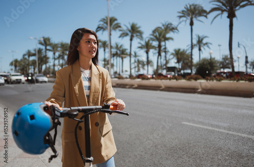 Young woman using e scooter to explore town