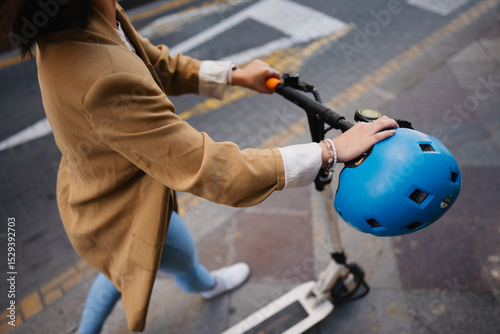 Image of woman using e scooter in town, close up