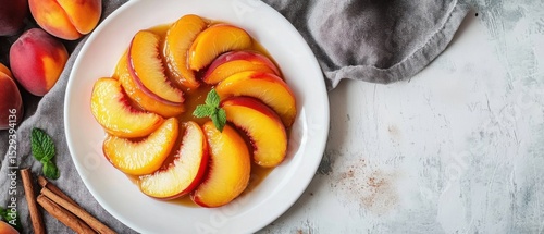 Tarte Tatin in a white plate with peach slices and cinnamon