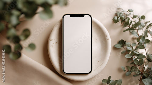 Modern Smartphone on Ceramic Plate Surrounded by Green Eucalyptus Leaves