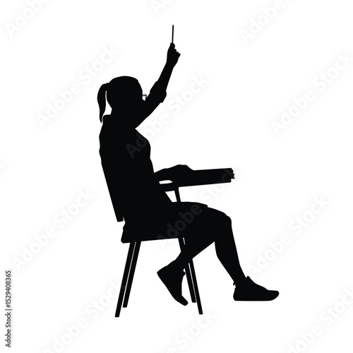 Silhouette of a female student sitting at a desk with her hands up