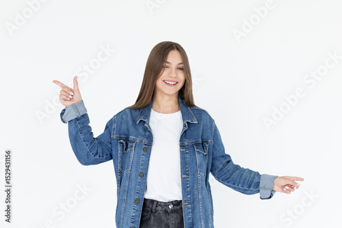 Image of beautiful woman pointing fingers left and right, making decision, showing two variants choices, standing over white background