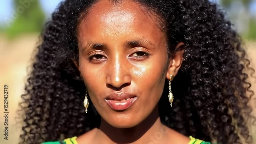 Beautiful Ethiopian Woman with Radiant Brown Skin & Golden Undertones, Large Bright Eyes and Traditional Earrings – Sunlit Elegant Portrait + Concept