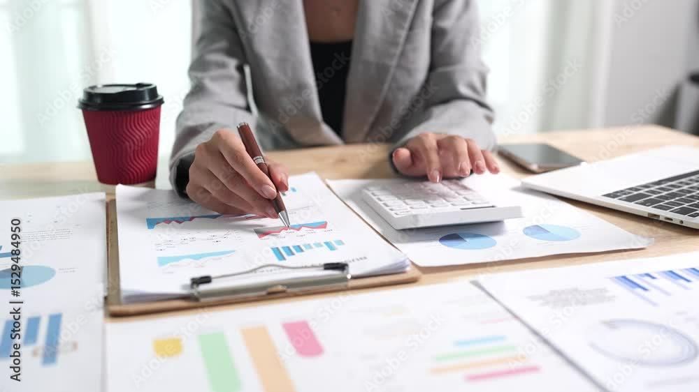 Businessman analyzing financial charts and documents at office desk, focused on planning, investment, accounting, growth strategy, and corporate success.