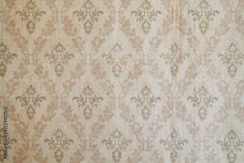 Old wallpaper on the wall. Old wallpaper for texture or background.