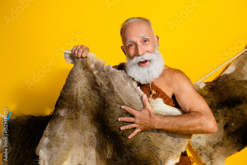Photo of funky primeval man dressed leopard fur smiling showing animal skin copy space isolated yellow color background