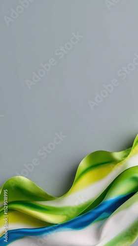 Abstract Green Blue Yellow Silk Fabric Draped on Gray Background