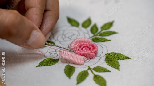 Floral Needlework: Hand Stitching a Rose Flower with Pink Thread on Fabric