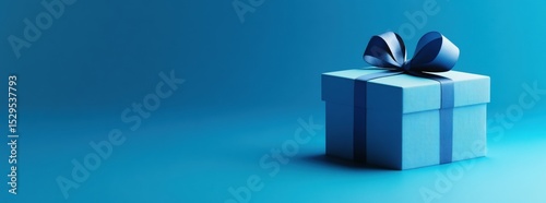 Close-up of elegant blue gift box with satin ribbon on dark gradient background. Soft studio lighting. Luxurious and festive atmosphere. Perfect for celebrations, branding, or holiday promotions